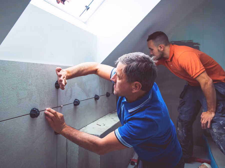 The Bell and Son team tiling a bathroom on site
